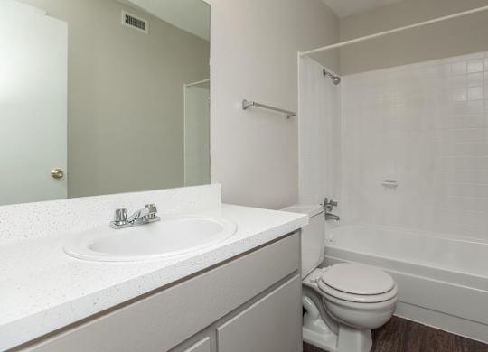 an empty bathroom with a sink toilet and shower