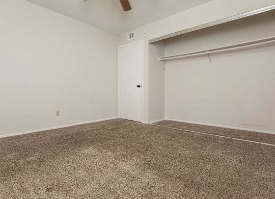 an empty room with carpet and a garage door
