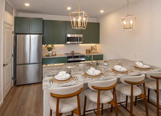 A kitchen with a marble countertop and a refrigerator.