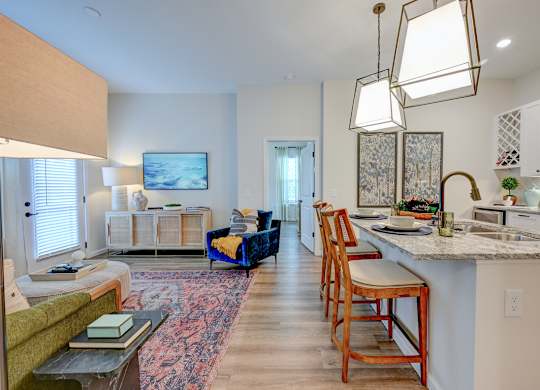 A modern kitchen with a dining table and chairs.