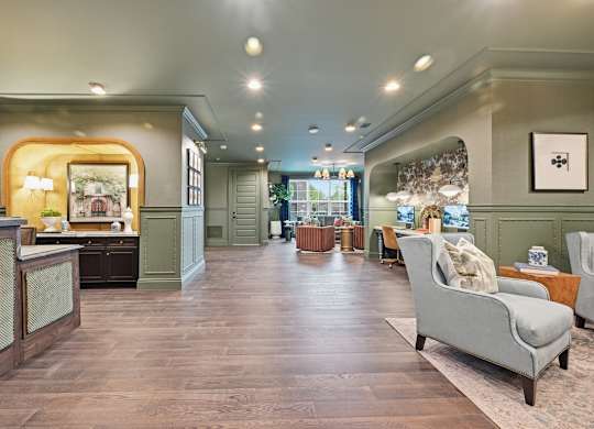 A living room with a grey sofa and wooden floors.