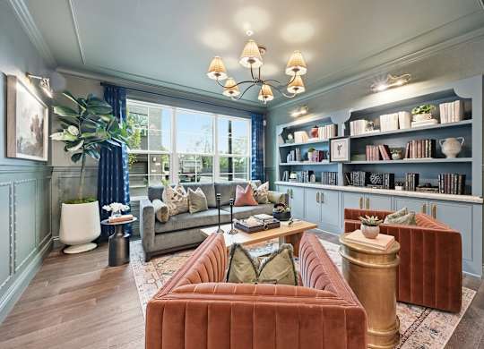 A living room with a red couch and a grey sofa.