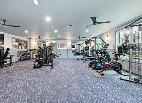 A spacious gym with a variety of exercise equipment.