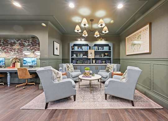 A living room with grey chairs and a coffee table.
