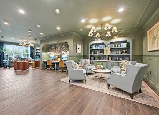 A living room with a grey sofa and a wooden floor.
