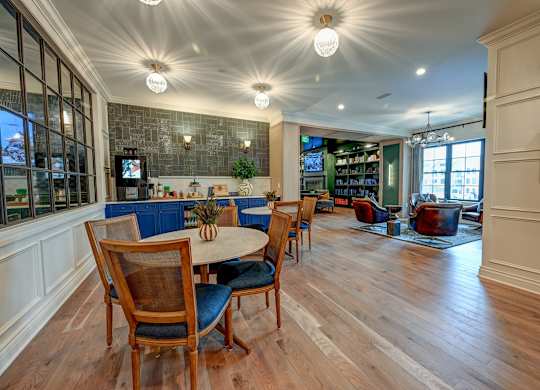 A dining room with a table and chairs.