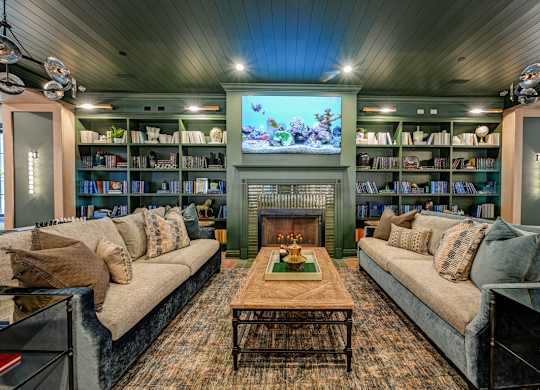 A living room with a fireplace and a television.