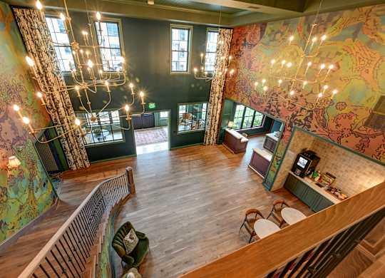 A room with a wooden floor and a large mural on the wall.