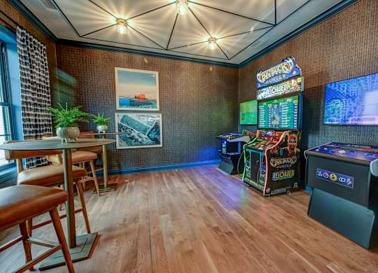 A room with a wooden floor and a wall with a picture of a boat on it.