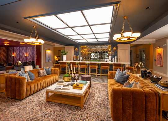 A living room with a brown couch and a coffee table.