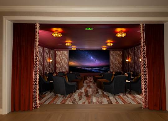 A room with a stage and chairs.