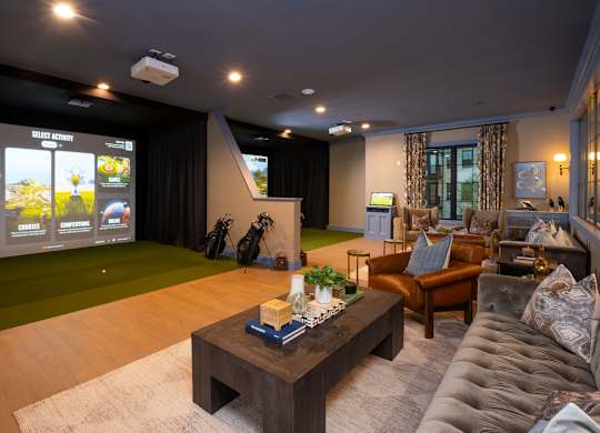 A home theater room with a large screen and comfortable seating.