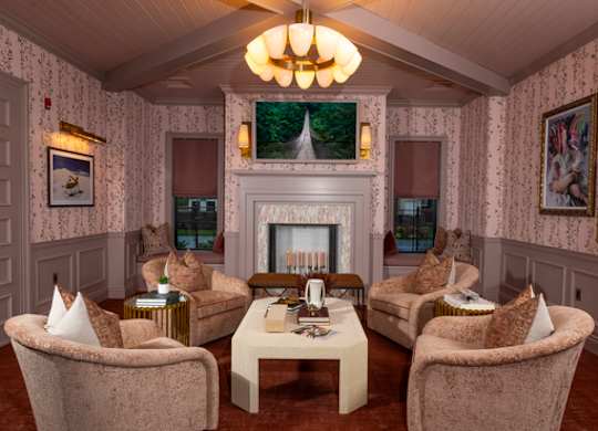 A living room with a fireplace and a chandelier.