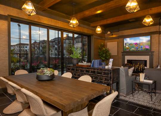 A modern dining room with a wooden table and chairs.