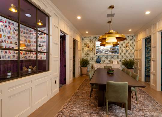 A dining room with a table set for six.