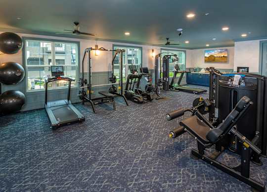 A spacious home gym with a variety of exercise equipment.