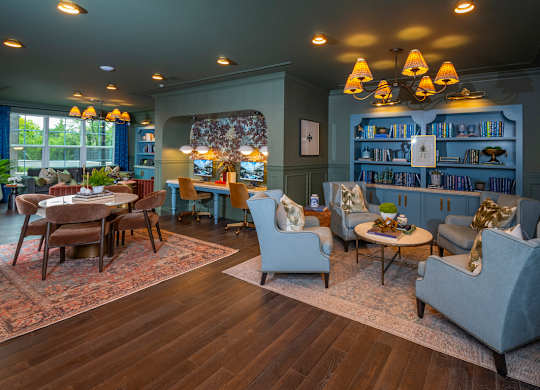 A living room with a wooden floor and a large rug.