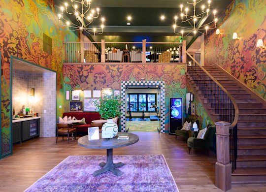 A living room with a staircase and a couch.