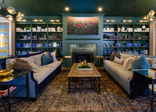 A living room with a fireplace and a bookshelf.