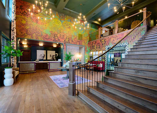 A staircase with a metal railing leads up to a second floor.