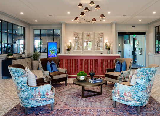 Modern lobby with stylish seating and chandelier at Fairmont Apartments, Westerville, Ohio
