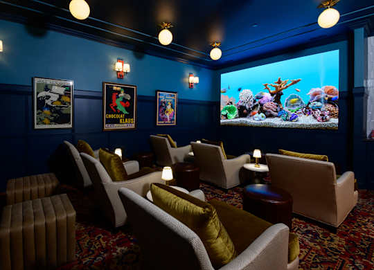 Private theater room with aquarium and lounge seating at Fairmont Apartments, Westerville, OH