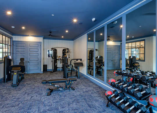 Fitness center with weights and exercise equipment at Fairmont Apartments, Westerville, 43081