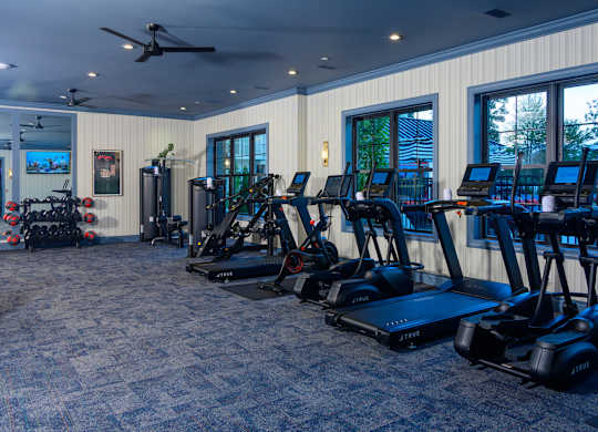Fitness center with cardio equipment and weights at Fairmont Apartments, Westerville, Ohio