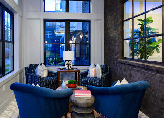 Elegant lounge area with blue velvet sofas at Fairmont Apartments, Westerville, OH
