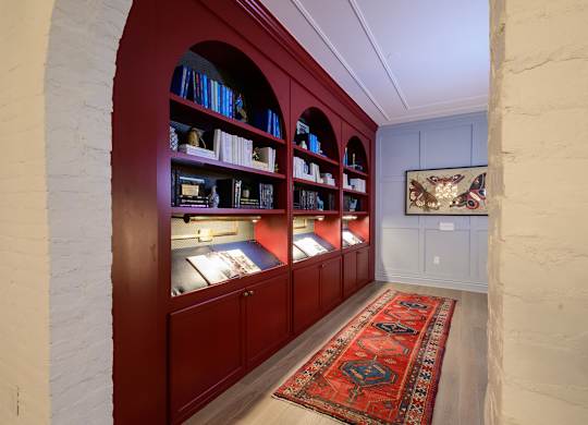 Study room with red builtin shelving and display cases at Fairmont Apartments, Westerville