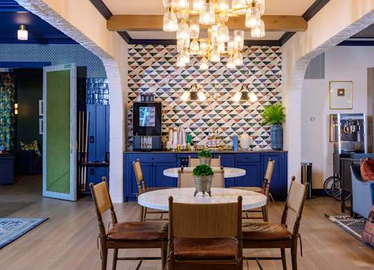Elegant dining area with chandelier and patterned backsplash at Fairmont Apartments, Ohio