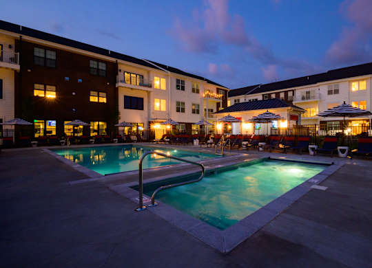 Evening view of pool and spa with courtyard at Fairmont Apartments, Ohio
