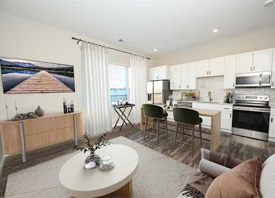 A modern kitchen with a dining area and a living room.