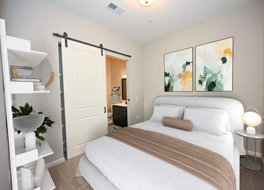 A bedroom with a bed, nightstand, and a painting on the wall.