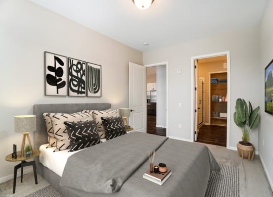 a bedroom with a bed and a door to a bathroom at Essex, Columbus, 43212