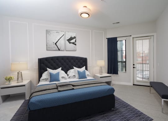a bedroom with a bed and a door leading to a balcony at Fairfax, Grandview, OH, 43212