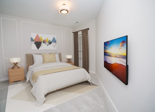 a bedroom with a bed and a painting on the wall at Fairfax, Ohio