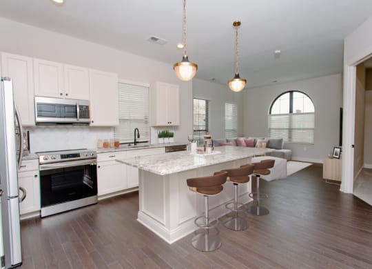 a kitchen and living room with white cabinets and a white counter top at Fairfax, Grandview, OH