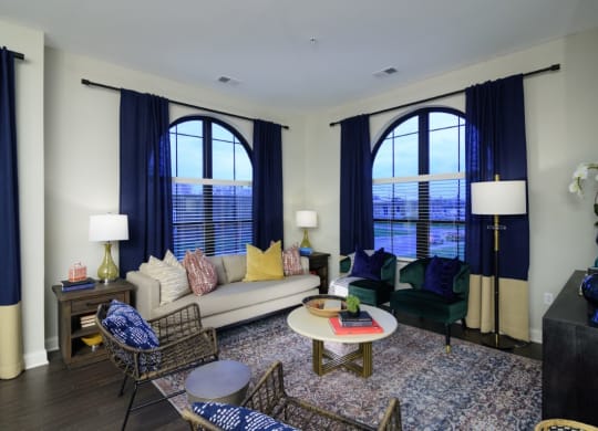 a living room with large windows and a couch and chairs at Fairfax, Ohio, 43212