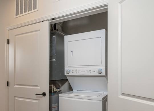 A white dishwasher is built into a wall in a kitchen.