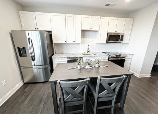 a kitchen with white cabinets and stainless steel appliances at Fairfax, Grandview, OH, 43212
