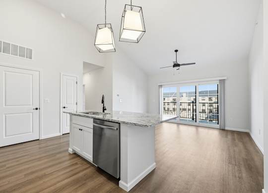 A kitchen with a marble countertop and stainless steel appliances.