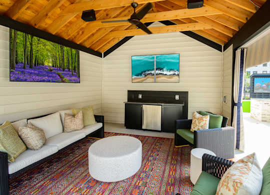 A living room with a white couch and a fireplace.
