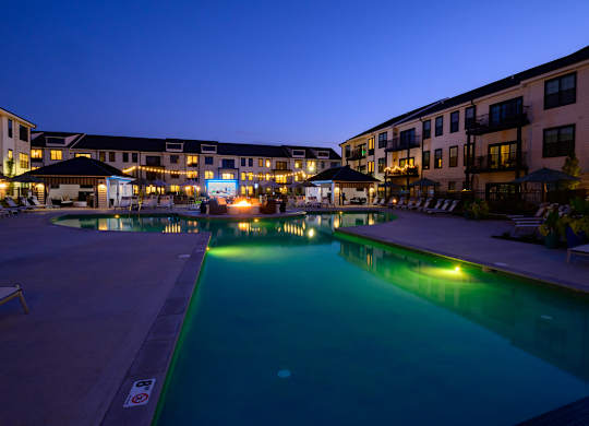 A swimming pool in a resort at dusk.