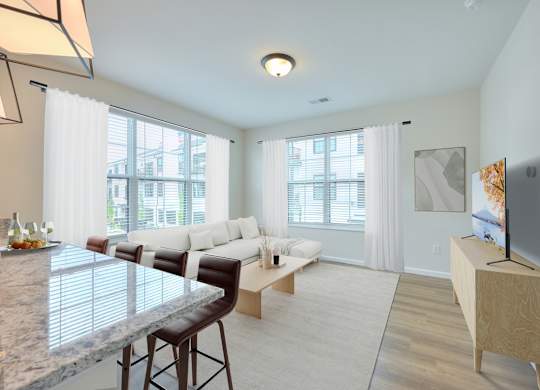 A modern living room with a marble countertop and white furniture.