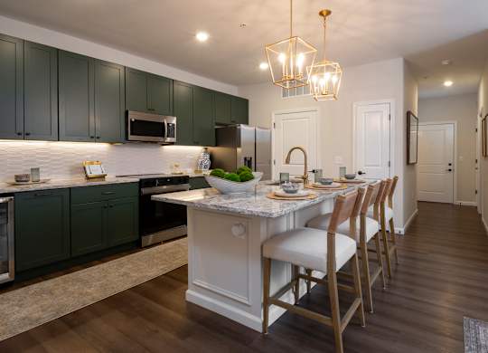 A kitchen with a table and chairs in the middle of the room.
