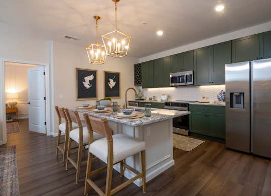 A kitchen with a table and chairs.