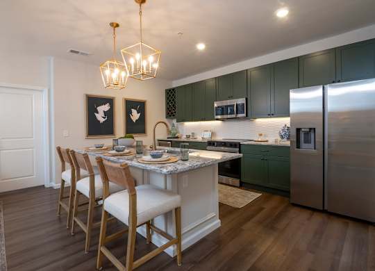A kitchen with a table and chairs.