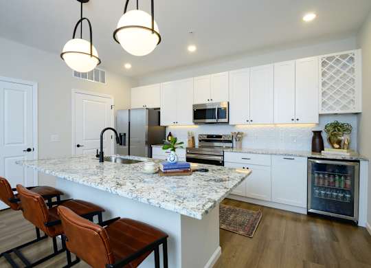 A kitchen with a marble countertop and white cabinets. at Fairmont Apartments, Ohio