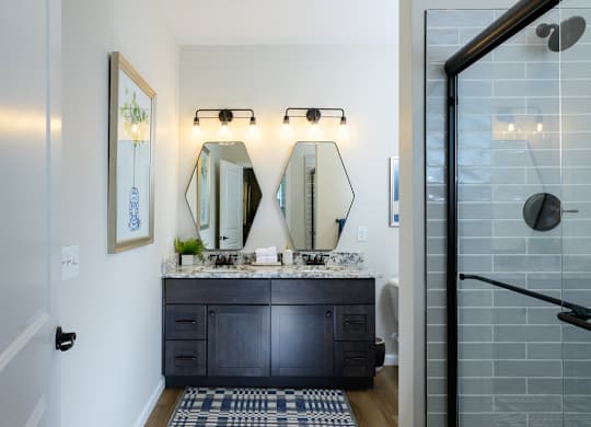 A bathroom with a vanity and a mirror above it. and lounge chairs at Fairmont Apartments, Westerville, OH